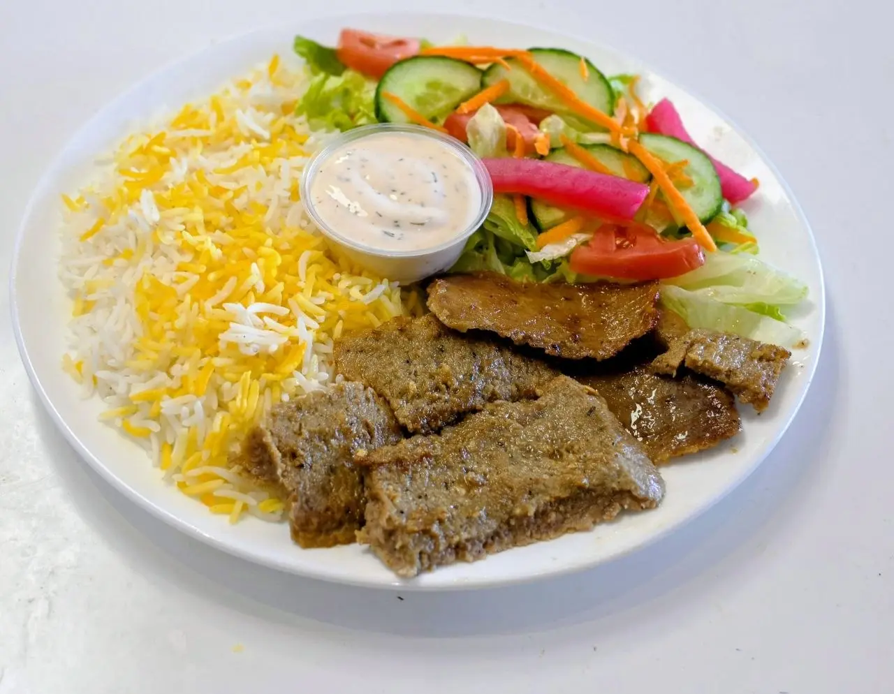 Beef gyro lunch special with rice, salad and sauce