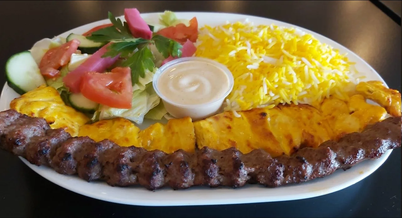 Vaziri kebab with chicken kebab, beef koobideh, basmati rice, salad and grilled tomato